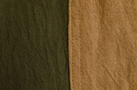 Texture of brown and green natural dye fabric crumpled. Selective Focus. Suitable for use background and place text over photo.の写真素材