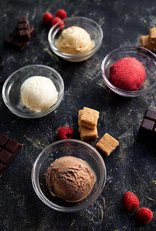 Various of ice cream flavor in glass sups on black background