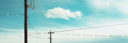 Electricity post with blue sky and white clouds. Panorama.の素材
