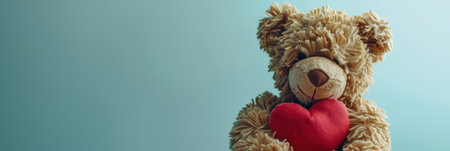 Teddy bear with red heart on blue background, valentine's day conceptの素材