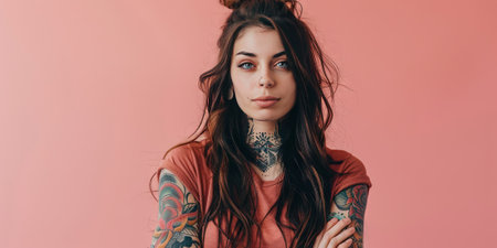 Portrait of a beautiful young woman with tattoos on her arms, looking at the camera.の素材