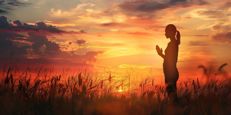 Silhouette of pregnant woman on the meadow at sunset.の素材