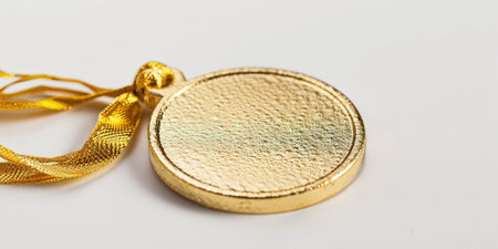 Gold medal on a white background, close-up, selective focusの素材