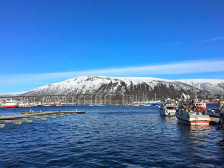 The port of Tromso in northern Norway. The city bridge in connects the city center to the mainland.の写真素材