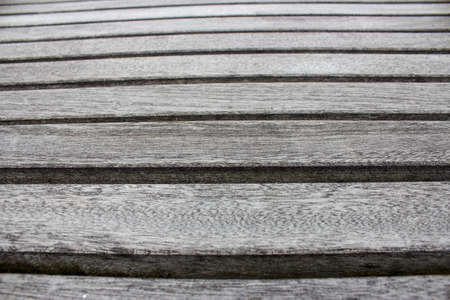 A close up of a wooden bench.