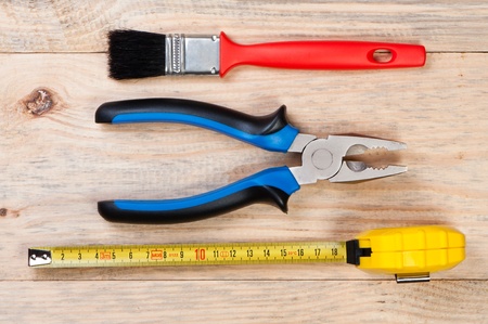 Building tools on wooden background.