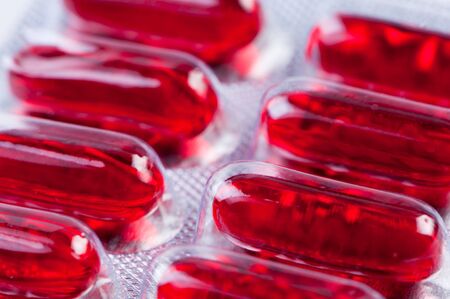 Red pills in packing close up.