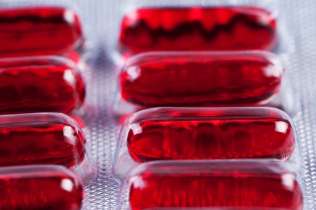 Red pills in the pack close up. Theme of Medicine and Health.