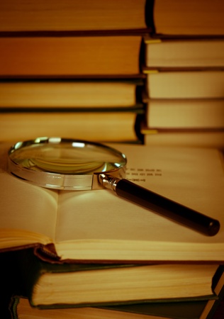 Books with magnifying glass. Concept education and science.の写真素材
