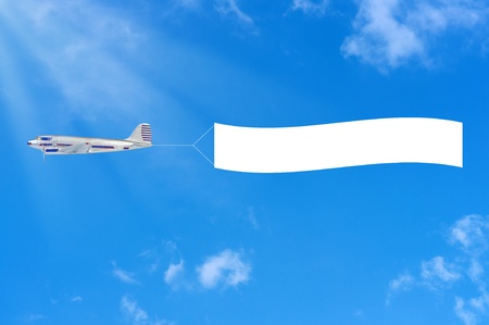 Flying airplane and banner on sky background.の写真素材