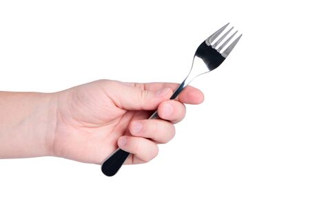 Hand holds fork isolated on white background.の写真素材