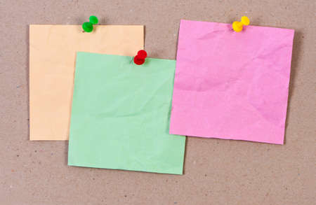 Crumpled sticky notes attached thumbtack.の写真素材