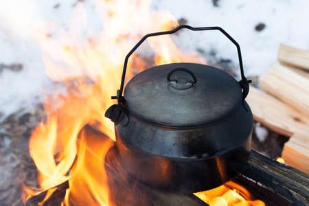 Sooty camp kettle on a fireの写真素材