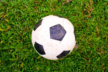 The sloppy play football on the grass.の写真素材