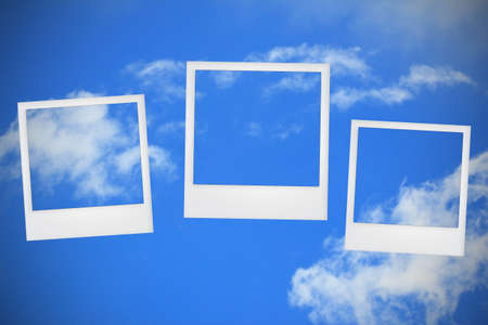 blank photo frames on blue skyの写真素材