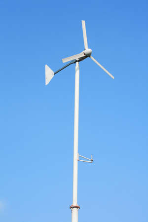 white wind turbine on clear blue sky. の写真素材