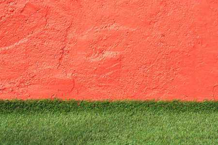 orange wall with grass background.の写真素材