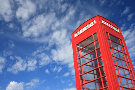 red telephone box with blue sky.の写真素材