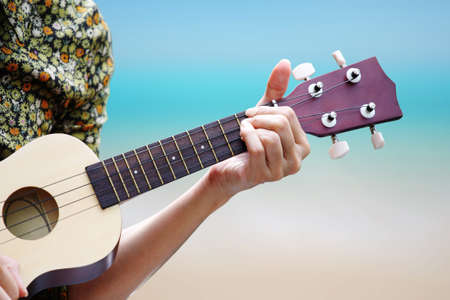 hand picking Guitar ,Ukulele on the beach 