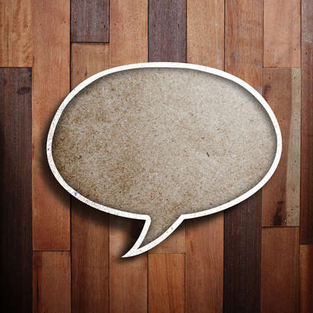paper speech bubble on wood background 