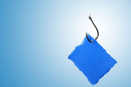 hook and paper bait with copy space on blue background の写真素材