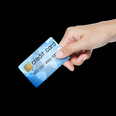  credit card holded by hand over blue background の写真素材