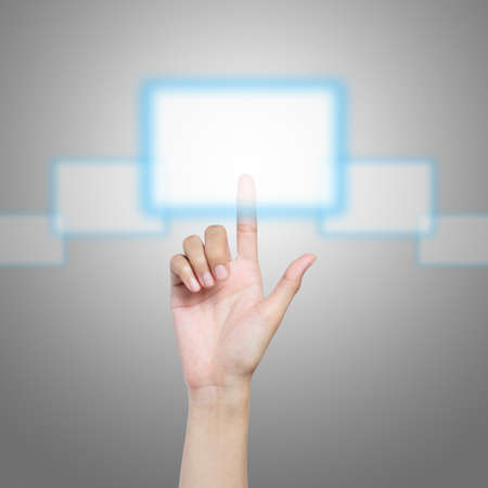 Hand pressing virtual button on futuristic holographic screenの写真素材