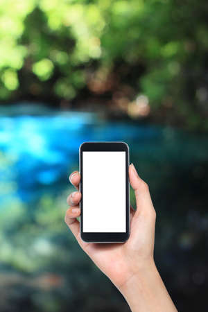 mobile phone in nature backgroundの写真素材