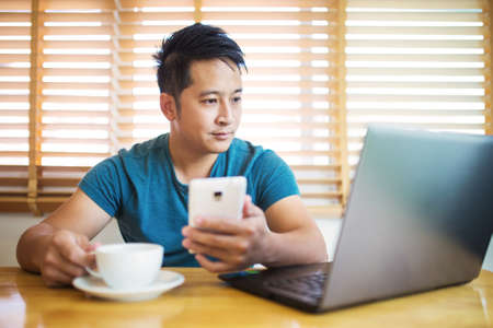 Young man wearing casual cothes working at home.の写真素材