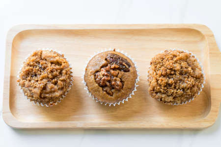 Banana crumble cup cake on wood plate.の写真素材