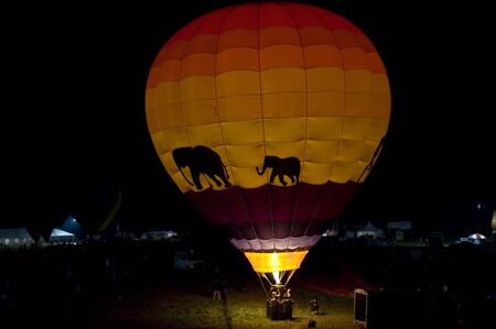 A hot air balloon glowing at night.の写真素材