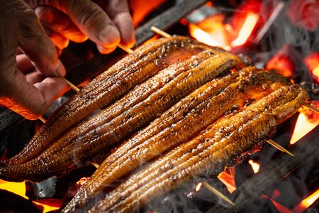 Baking eels at an eel restaurant in Japanの写真素材