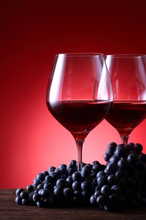 Two glasses of wine and grapesの写真素材