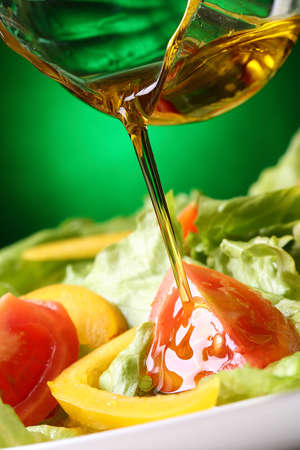 put olive oil on a saladの写真素材