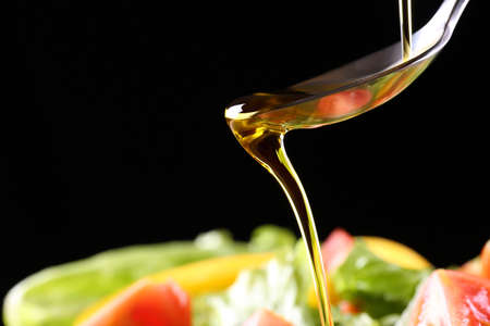put olive oil on a saladの写真素材