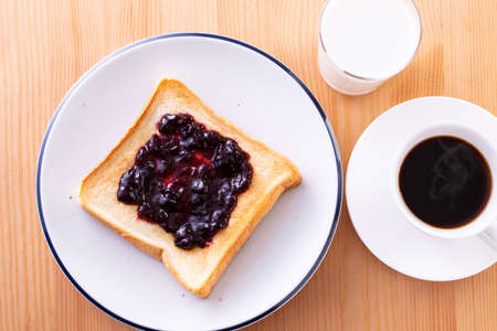 Toast and coffee with blueberry jam