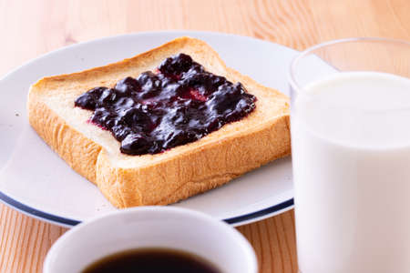 Toast and coffee with blueberry jamの写真素材