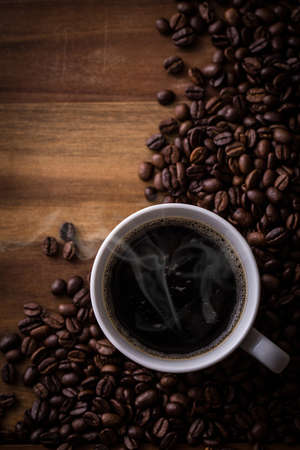 Hot coffee and coffee beans on the tableの写真素材