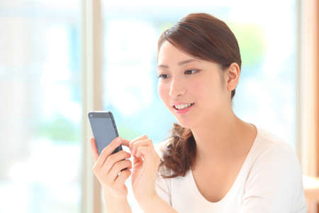Young woman with smartphoneの写真素材