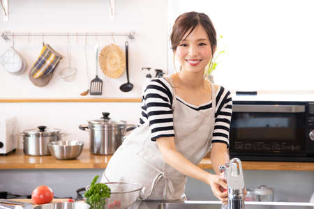 Young women cooking in the kitchenの写真素材