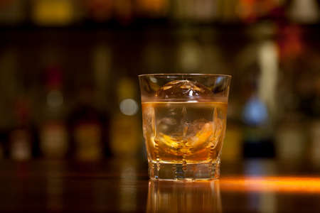 drink whiskey at the counter of the barの写真素材