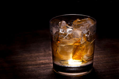 drink whiskey at the counter of the barの写真素材