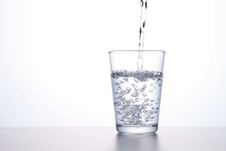 pour water into a glassの写真素材