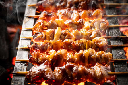 Yakitori is grilled at a yakitori restaurant in Japan.の写真素材