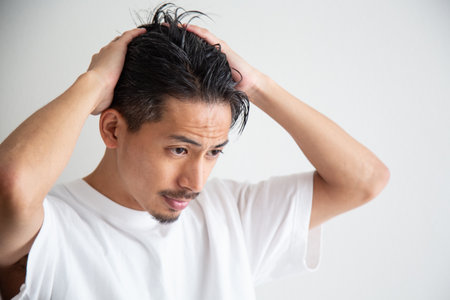 A man in his 30s who cares about his hairの写真素材