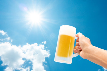 Drinking draft beer under the blue skyの写真素材