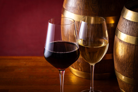 Two glasses of wine and a barrel
