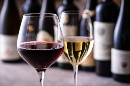 Wine bottles and glasses with red, white and rose wines.