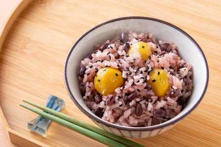Japanese rice with egg in a bowl and chopsticks on the tableの写真素材