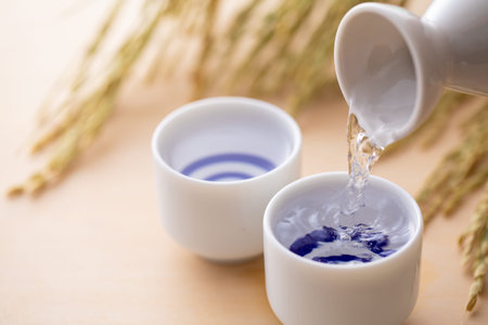 Liquid in a white porcelain cup on a wooden tableの写真素材